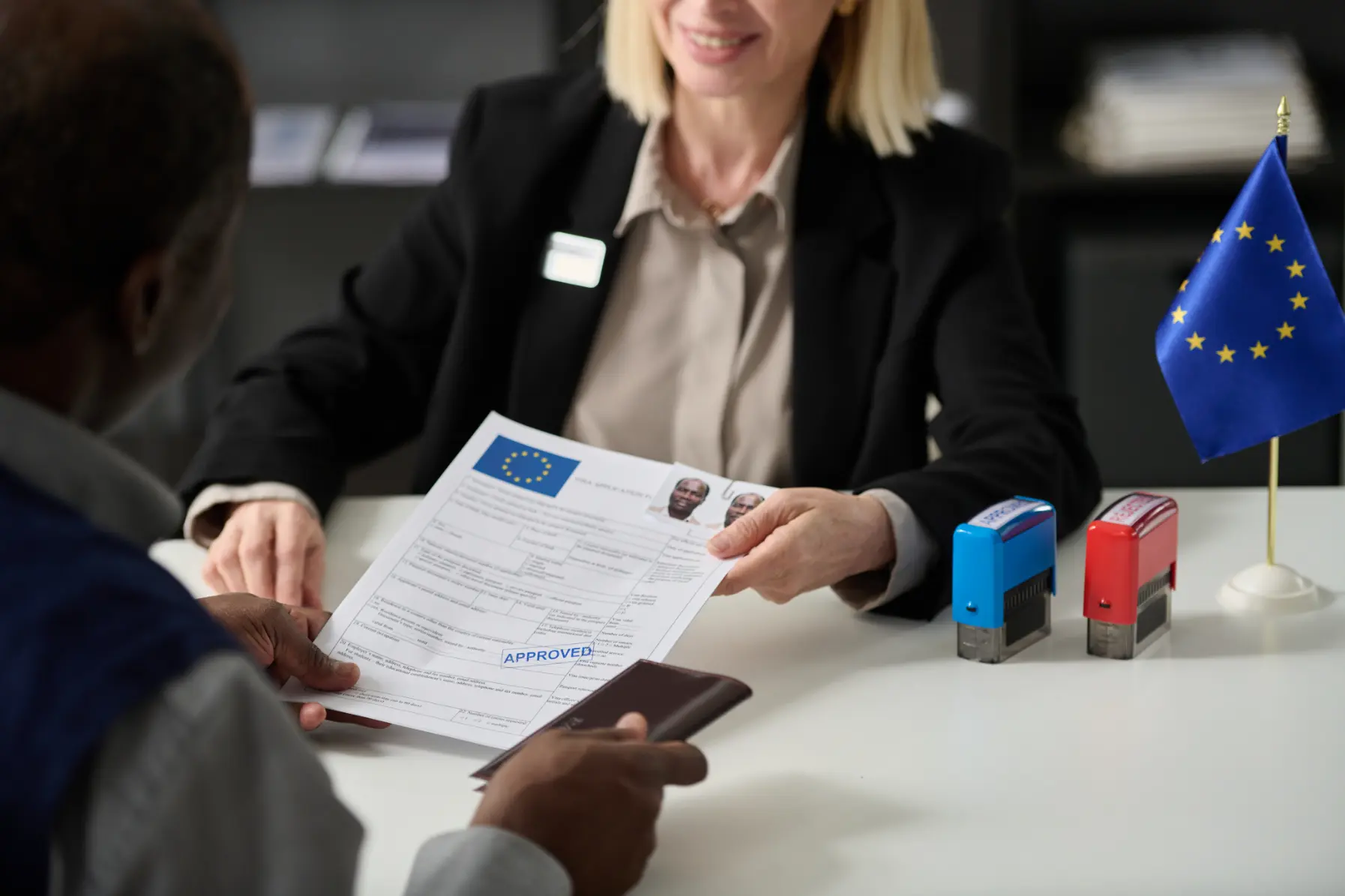 close-up-of-smiling-woman-handing-approved-visa-2026-01-09-00-46-40-utc (1)